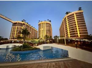 a bridge in front of two tall buildings at Ideal Budget and Cozy Private Studio with Amazing Pool by SYM C738 in Phnom Penh