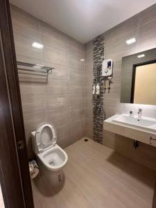 a bathroom with a toilet and a sink at Ideal Budget and Cozy Private Studio with Amazing Pool by SYM C738 in Phnom Penh