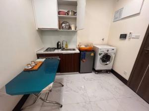 a small kitchen with a sink and a washing machine at Ideal Budget and Cozy Private Studio with Amazing Pool by SYM C738 in Phnom Penh