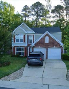 a car parked in the driveway of a house at A spacious and warm house in Fuquay-Varina
