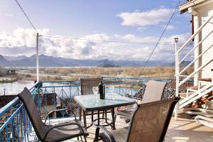 a patio with a table and chairs on a balcony at JG Sunny Balcony apartment Skadar Lake in Podgorica
