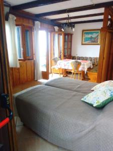 a bedroom with a bed and a dining room with a table at Ulisse sul Sentiero in Praiano