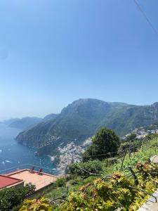 a view of a mountain with a city and a body of water at Ulisse sul Sentiero in Praiano