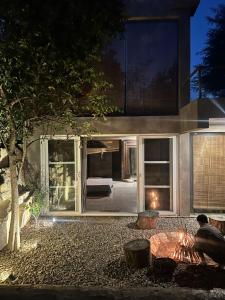 a house with sliding glass doors and a bed at THE BAREWITHIN HOUSE in Jaipur
