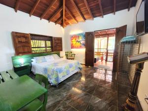 a bedroom with a bed and a table and chairs at PaloSanto, Casa Rural in Jardin