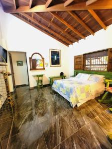 una camera con letto e soffitto in legno di PaloSanto, Casa Rural a Jardin