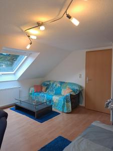 a living room with a couch and a glass table at Les Papillons in Tennenbronn