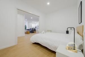 1 dormitorio con cama blanca y espejo grande en Smart Apartment 3pax en Madrid Rio con Parking, en Madrid