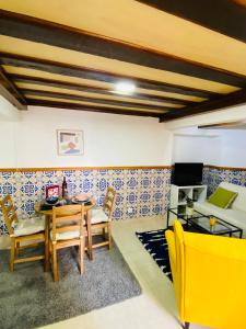 a dining room with a table and chairs and a couch at Alfama Charm Apartments - Authentic Lisbon Experience in Lisbon