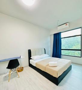 Schlafzimmer mit einem Bett, einem Schreibtisch und einem Fenster in der Unterkunft Jesselton Quay by Adara Suites in Kota Kinabalu