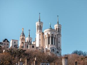 a building with towers on top of a hill at L'Académie Hôtel Lyon in Lyon