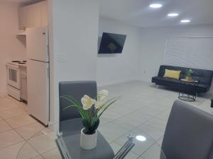 a living room with a table with a vase of flowers on it at Arpe 4plex in Fort Lauderdale