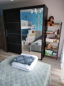 um quarto para crianças com um beliche e um espelho em Apartament W sam Raz em Słupsk