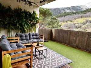 a patio with a couch and a table and a fence at Gredos Starlight House in Mijares