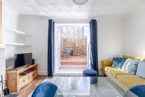 a living room with a couch and a glass table at Serene 2BD Flat wPrivate Patio Old Street! in London