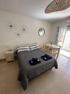 a bedroom with a bed with two towels on it at Departamento en planta baja con cochera in Salta