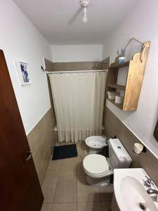 a small bathroom with a toilet and a sink at Departamento en planta baja con cochera in Salta