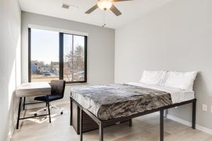 um quarto com uma cama, uma cadeira e uma janela em Modern Bloomington Apt Near Indiana University! em Bloomington