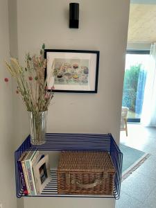 a table with a vase and a basket on it at Traumhaftes Ferienhaus am See am Lübbesee in Templin in Templin