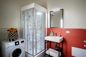 ein Badezimmer mit einer Dusche, einer Waschmaschine und einem Waschbecken in der Unterkunft Appartamenti vista mare Otranto in Otranto