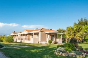 a large house with a green yard at Casa di Varco in Lefkada Town
