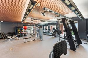 a gym with several treadmills and cardio machines at Houston Med Center Modern Queen Suite with Spa Amenities, Pool and Free Parking in Houston