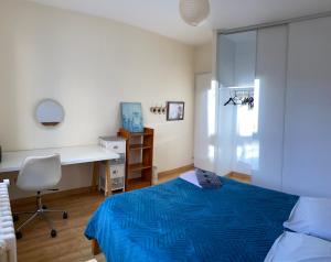 a bedroom with a bed and a desk and a desk at Chambre Angers gare-centre ville 2 in Angers