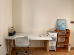 a white desk with a white chair and a shelf at Chambre Angers gare-centre ville 2 in Angers