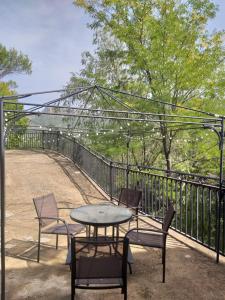 a patio with a table and chairs and a fence at CASAS RURALES LA TOBICA in Yeste