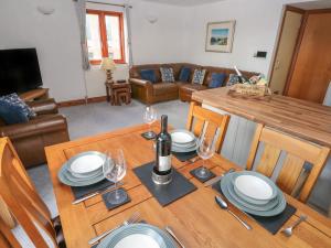 a dining room with a table with plates and wine glasses at The Sail Loft in Milford Haven