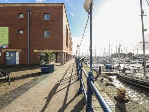 a marina with boats in the water and a building at The Sail Loft in Milford Haven