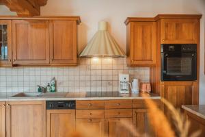 a kitchen with wooden cabinets and a sink at Chalet Ninni in Kitzbühel