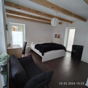 een slaapkamer met een bed en een bank bij Apartment "Stine" in Erpen