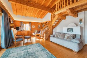 a living room with a couch and a staircase at Chalet Ninni in Kitzbühel