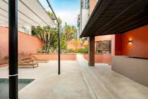 a courtyard of a building with a patio at Casa Penta Top Notch Villa in Medellín