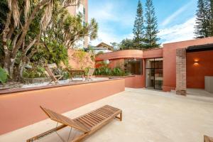 a patio with a chair and a house at Casa Penta Top Notch Villa in Medellín +84 photos