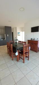 a dining room with a table and wooden chairs at DPTOS 3 DE FEBRERO in San Pedro