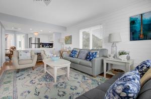 a living room with a couch and a table at 204 B Port O Call by AvantStay Beachfront Condo in Isle of Palms