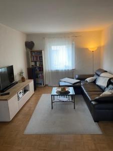 a living room with a couch and a table at Artgerecht Naturverliebt in Bad Berleburg