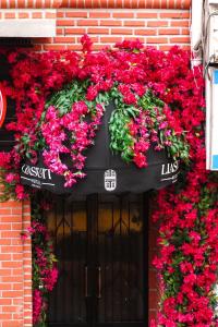 a black door with a bunch of red flowers at Lia Suit Beşiktaş in Istanbul