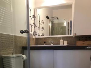 a bathroom with a sink and a mirror at C&C Apartments in Alexandroupoli