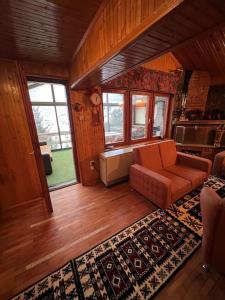 a living room with a couch and a rug at Chalet Hilltop Kodra e Diellit Popovo Sapka in Tetovo