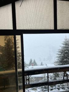 a view of a snow covered field from a window at Chalet Hilltop Kodra e Diellit Popovo Sapka in Tetovo