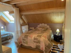 a bedroom with a bed in a attic at Le Gite De L'etoile Du Jour in Neung-sur-Beuvron