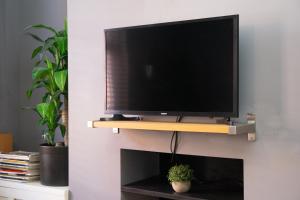 a flat screen tv sitting on top of a fireplace at Townhouse in trendy suburb of Hoole in Chester +22 photos