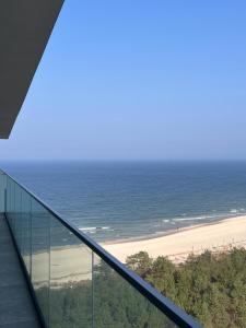 a view of the beach from the top of a glass building at Wave - Sea View Resort&SPA E11112 in Międzyzdroje