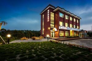 a large building with benches in front of it at Jeju Wayo Pension in Jeju
