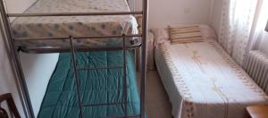 a couple of bunk beds in a small room at Habitacion Privada Triple Toledo in Toledo