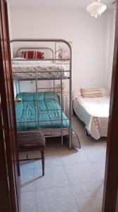 a room with two bunk beds and a bed at Habitacion Privada Triple Toledo in Toledo
