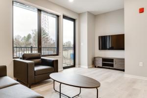 sala de estar con TV, sofá y mesa en Bloomington Apartment with Balcony, 3 Mi to Downtown, en Bloomington